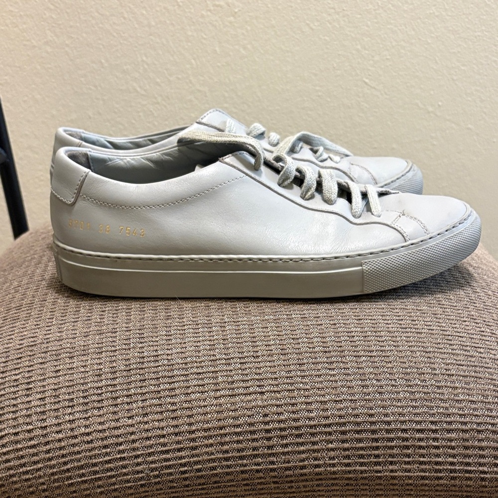 Woman by Common Projects gray shoes